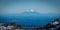 Snow covered Mount Taranaki, or Egmont, an active volcano, viewed from far away in tongariro national park, New Zealand.