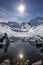 The snow-covered mountain and its reflection in Lac du Lou near Val Thorens resort