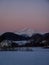 Snow covered mountain peak during pink colorful sunrise