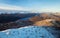 Snow covered mountain peaks and lake at sunset