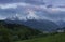 Snow covered mountain peaks of Watzmann and city Berchtesgaden with clouds during sunset, Bavaria