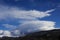 Snow-covered mountain in the Pyrenees covered with lenticular clouds, France