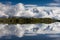 Snow-covered mountain range mirroring in a lake