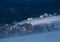 Snow covered mountain slope in last evening sunlight. Magnificent windy dusk on picturesque alpine resort, Dragobrat, Ukraine,