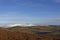 The Snow covered mountains of the Angus Glens from the Heather covered Lower Ramparts of the White Caterthun.