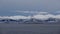 Snow covered mountains and atlantic ocean on Hinnoya near Myrland in winter in Norway