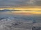 Snow covered mountains overlooking Salt Lake City in winter with glow of rising sun