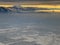 Snow covered mountains overlooking Salt Lake City in winter with glow of rising sun