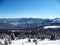 Snow covered mountains peaks with hills covered fir-tree forest. Winter landscape of the Carpathians in Ukraine