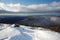 snow-covered mountaintop, with a view of the valley below