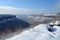 snow-covered mountaintop, with a view of the valley below