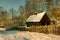 Snow-covered old wooden rural hut