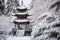 a snow-covered pagoda in serene forest setting