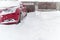 Snow covered parked car in a snowdrift