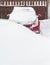 Snow covered parked car in a snowdrift