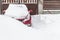 Snow covered parked car in a snowdrift