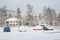 Snow covered parking lot, cars under