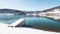 Snow covered pier on highland lake
