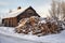 snow-covered pile of split firewood in winter