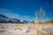 Snow-covered plain on the background of mountain peaks on a Sunny frosty day. Magnificent winter landscape in the mountains