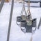 Snow covered playground with baby swings in Utah