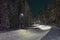 Snow-covered and plowed walkway illuminated with street light in Pitea
