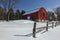 Snow Covered Red Barn and Split Rail Fence