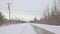 Snow covered road with electricity poles in Gatineau natural park, Quebec