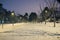 Snow covered roads in the night park with lanterns in the winter. Benches in the park during the winter season at night.