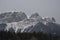 Snow Covered Rocky Mountains with Hazy Grey Sky