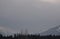 Snow Covered Rocky Mountains with Hazy Grey Sky