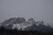 Snow Covered Rocky Mountains with Hazy Grey Sky