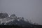 Snow Covered Rocky Mountains with Hazy Grey Sky