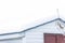 Snow covered rooftop of rustic country shed, background