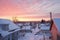 snow-covered rooftops under a soft winter sunrise