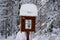 a snow covered signpost with a cartoon