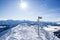 Snow-covered signpost at the top of the snowy mountain. winter sport achievement concept