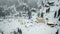 Snow-covered ski resort in the mountains with Christmas trees