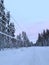 Snow-covered ski road for cross-country skiers skiing, thick layer of snow on wires, trees, Levi ski resort, tourism, winter