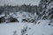 Snow-covered slope on the background of winter rocks