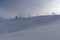 Snow covered slope with snow cannons and ski lifts