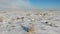 Snow-covered steppe with dry grass. Nature in winter, countryside. Fly forward over the land