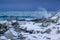 Snow-Covered Stones on the Ocean Coastline