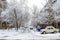 Snow covered street. snow-covered yard and cars