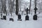 Snow-covered tombstones in Izborsk, Russia.