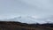 Snow-covered volcanoes of central Kamchatka in fog and clouds.