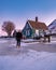 snow covered windmill village in the Zaanse Schans Netherlands, historical wooden windmills in winter Zaanse Schans