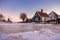 snow covered windmill village in the Zaanse Schans Netherlands, historical wooden windmills in winter Zaanse Schans