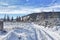 Snow-covered winter road in mountain valleys