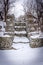 Snow-covered wire caged stone steps